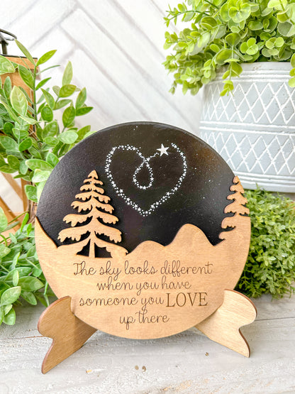 The sky looks a little different when you have someone you love up there. Wooden round with easel.