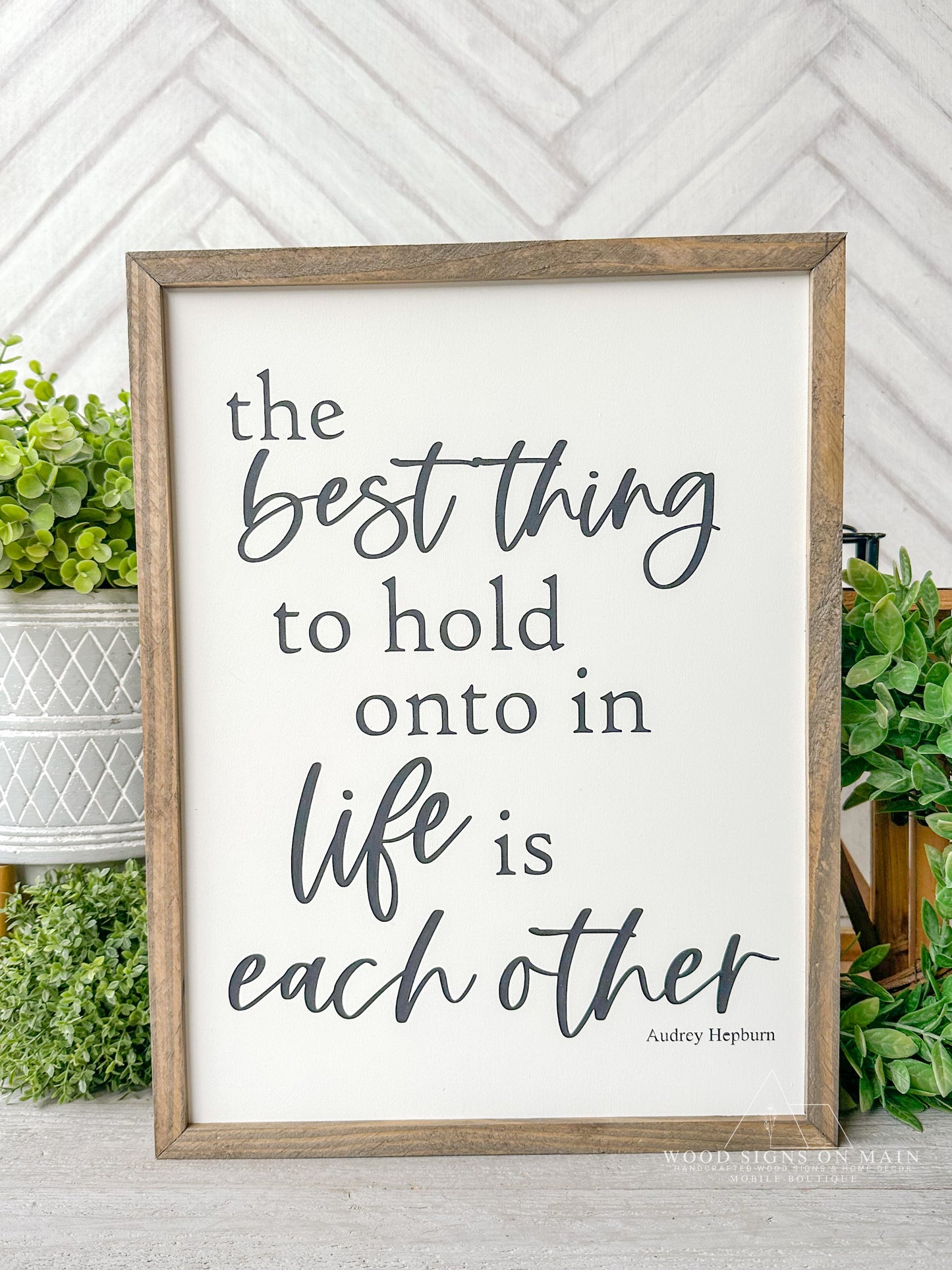 The best thing to hold on to in life is eachother. Hand painted wood sign.