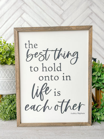 The best thing to hold on to in life is eachother. Hand painted wood sign.