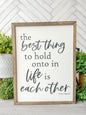 The best thing to hold on to in life is eachother. Hand painted wood sign.