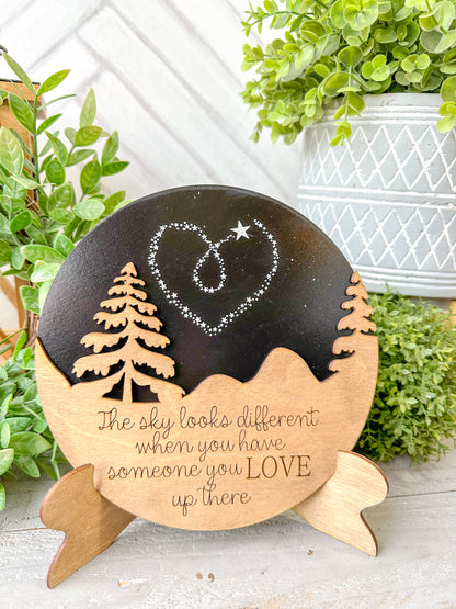 The sky looks a little different when you have someone you love up there. Wooden round with easel.