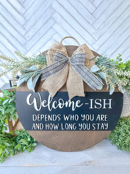 Funny Welcome-ish Sign - 18” Handcrafted Wood Round with Burlap Bow & Greenery