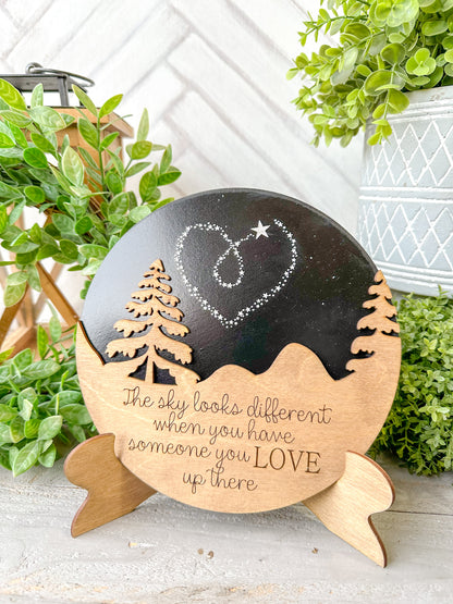The sky looks a little different when you have someone you love up there. Wooden round with easel.
