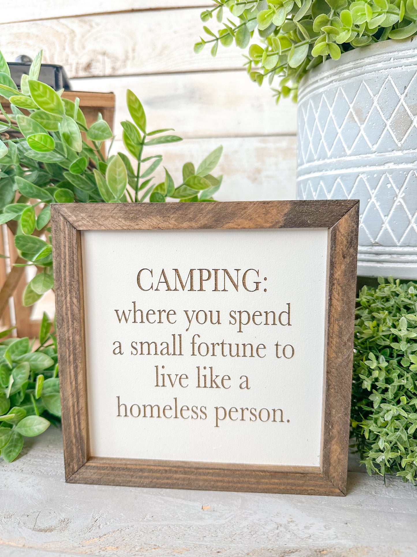Camping where you spend a small fortune to live like a homeless person. Laser engraved wood sign.