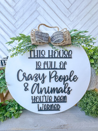 This house is full of crazy people & animals you’ve been warned. 18inch Door Hanger / Door Round.
