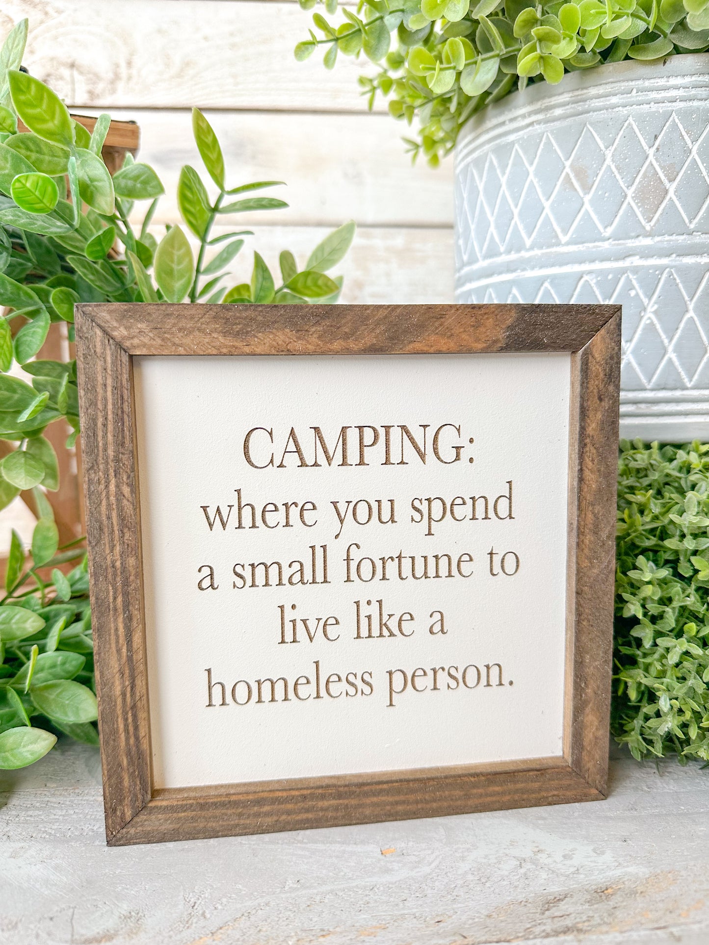 Camping where you spend a small fortune to live like a homeless person. Laser engraved wood sign.