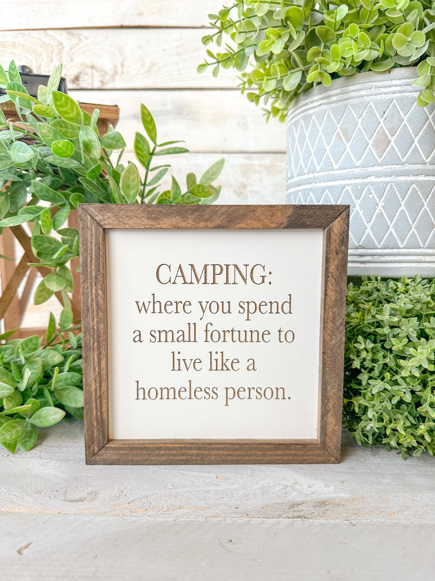 Camping where you spend a small fortune to live like a homeless person. Laser engraved wood sign.
