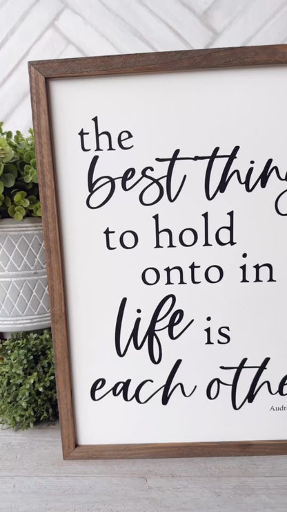 The best thing to hold on to in life is eachother. Hand painted wood sign.